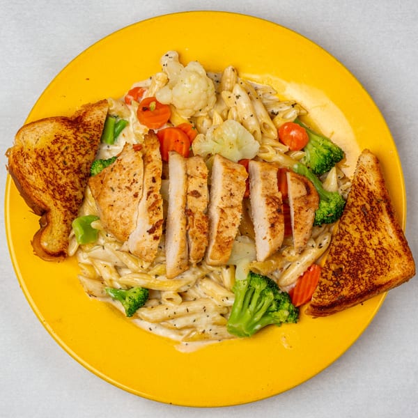 Oakcrest Family Restaurant's chicken alfredo with penne pasta, broccoli, carrots, cauliflower, and garlic toast.